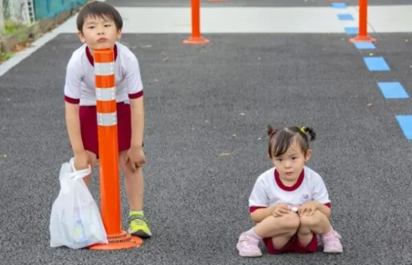 道路脇に立つ制服姿の男の子と女の子