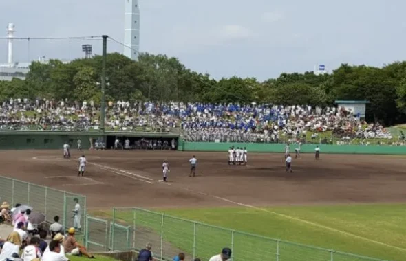 満員の観客席で行われる高校野球の試合